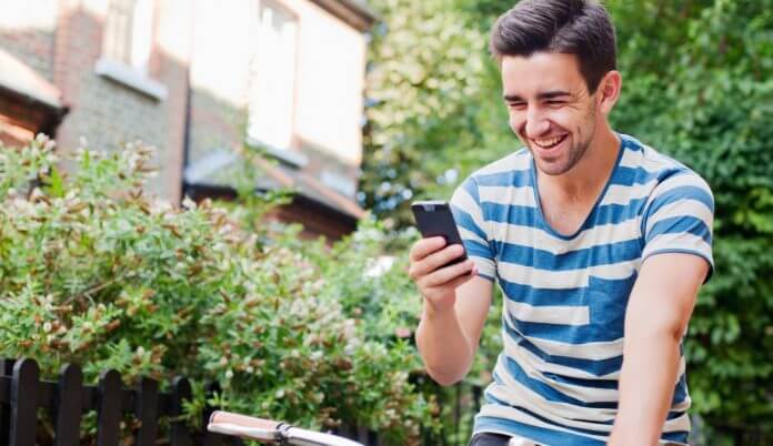 Upsets? Not for our members Young man using smart phone on bike